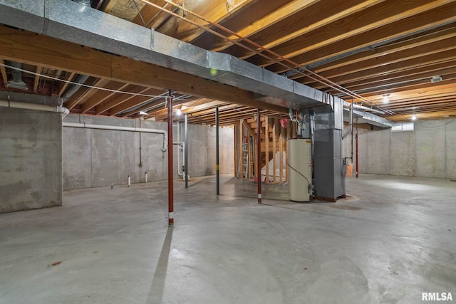 basement featuring gas water heater and heating unit