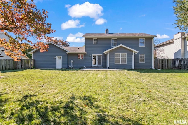 back of property featuring a patio area and a yard