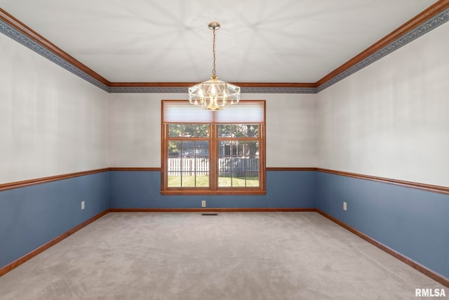 empty room with an inviting chandelier, ornamental molding, and carpet flooring