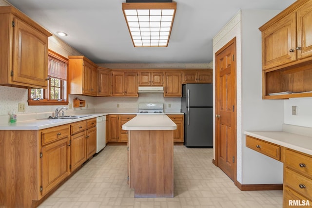 kitchen with white appliances, decorative backsplash, a center island, and sink