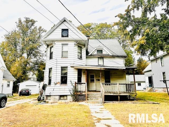 view of front facade with covered porch and a front lawn