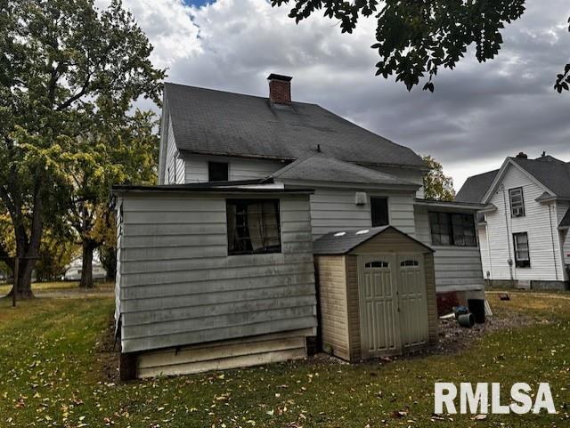 rear view of property with a yard