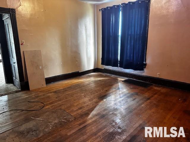 spare room with hardwood / wood-style floors