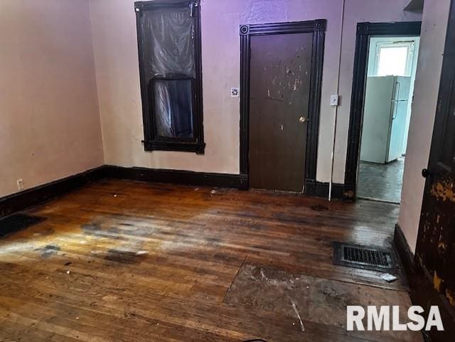 unfurnished room with dark wood-type flooring