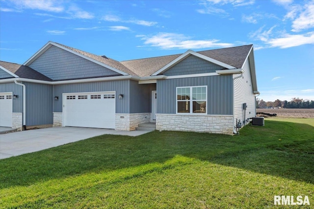 view of front facade with a front yard, a garage, and central air condition unit