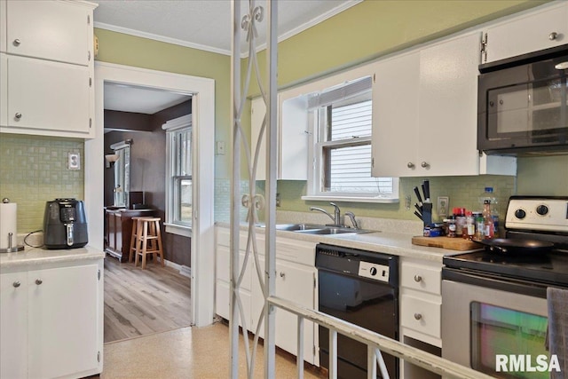 kitchen featuring dishwasher, electric range, white cabinetry, light hardwood / wood-style floors, and tasteful backsplash