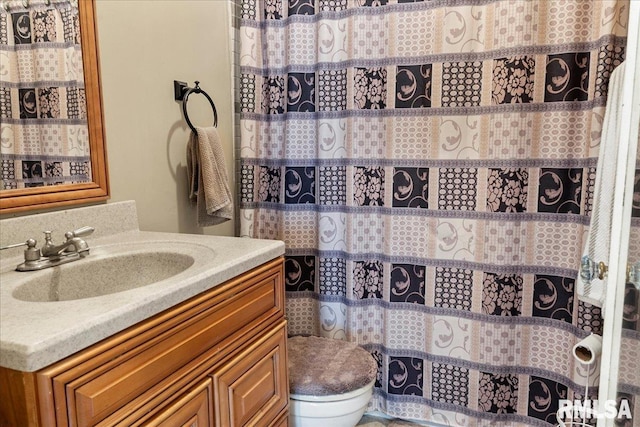 bathroom with vanity, walk in shower, and toilet