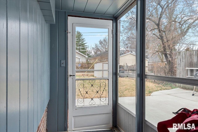 doorway featuring wood walls