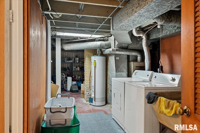 laundry area featuring water heater and washing machine and clothes dryer