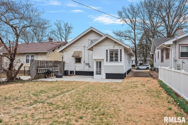 rear view of house featuring a patio area and a lawn