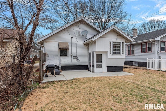 back of house featuring a patio area and a yard