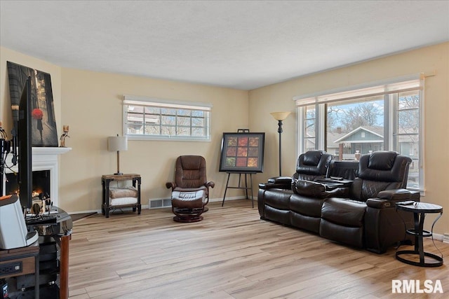 living room featuring a textured ceiling and light wood-type flooring