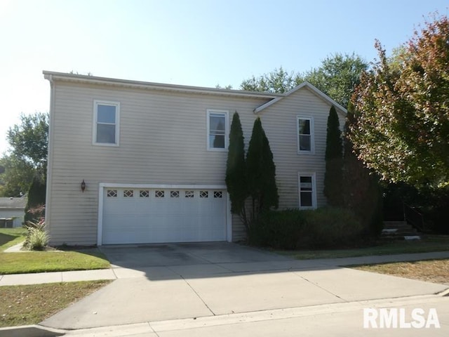 view of front facade featuring concrete driveway and an attached garage