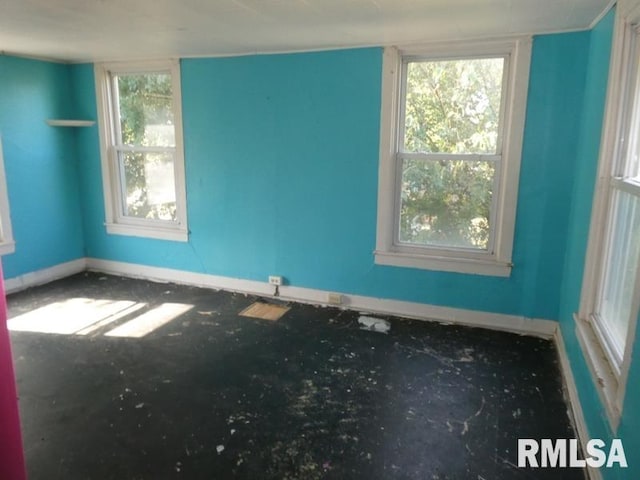 unfurnished room featuring baseboards