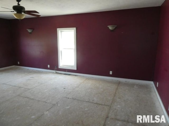 empty room with baseboards and a ceiling fan