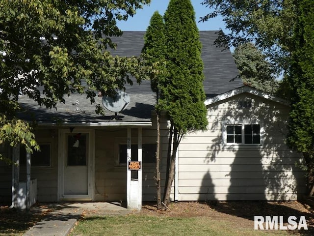 view of home's exterior with roof with shingles