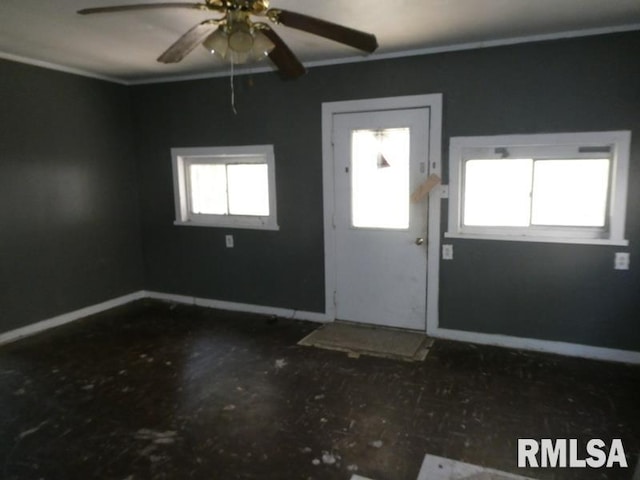 entryway featuring baseboards and a ceiling fan