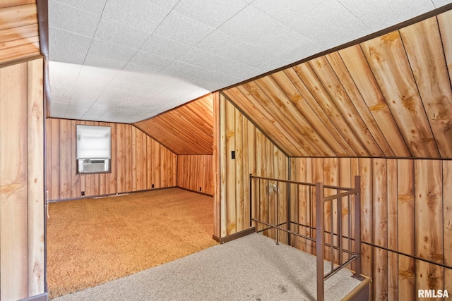 additional living space with wood walls, lofted ceiling, carpet floors, and cooling unit