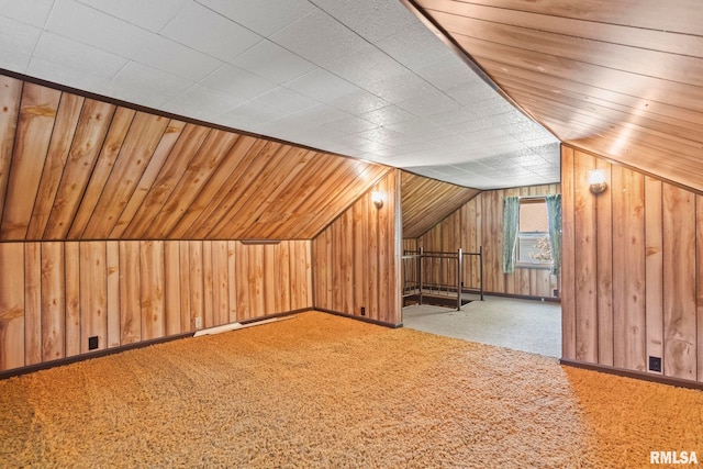 bonus room with wooden ceiling, carpet flooring, lofted ceiling, and wooden walls