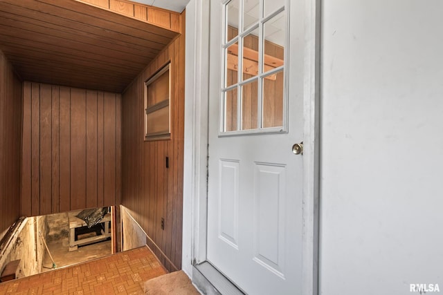 view of sauna / steam room featuring wooden walls and wooden ceiling