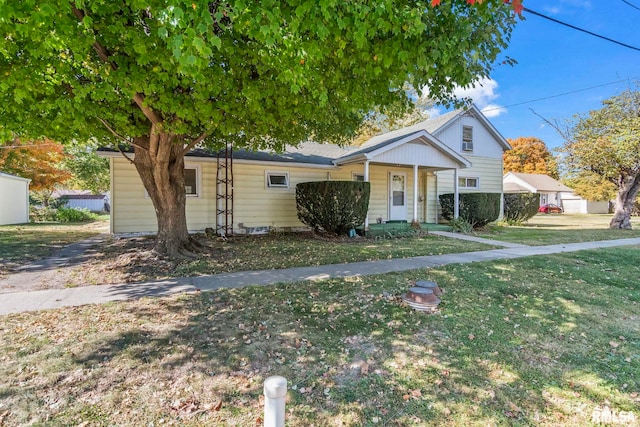 view of front facade with a front yard, a garage, and covered porch