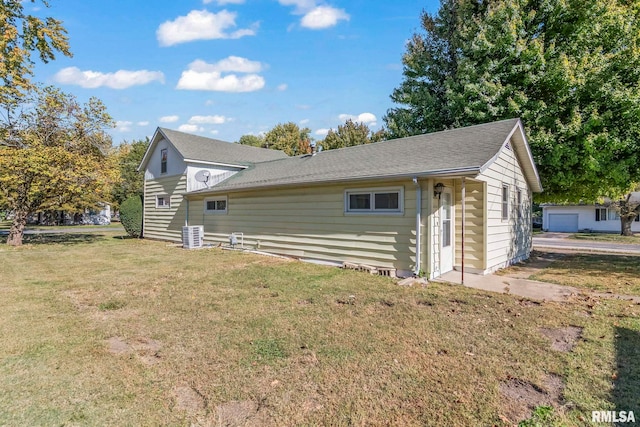 view of home's exterior featuring a yard, a garage, and an outdoor structure