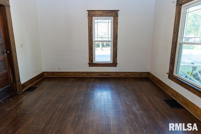 spare room with dark hardwood / wood-style floors