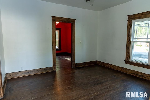 unfurnished room with ceiling fan and dark hardwood / wood-style flooring