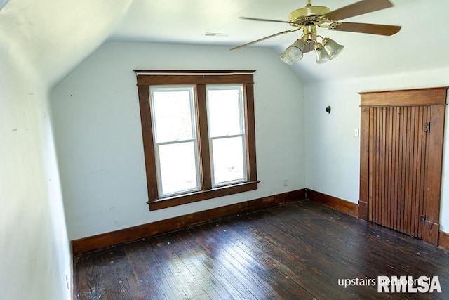 additional living space with dark hardwood / wood-style floors, ceiling fan, and vaulted ceiling