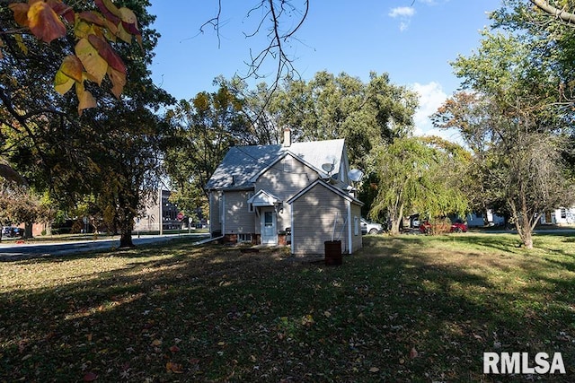 view of side of property with a yard