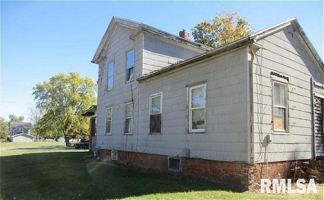 view of side of property with a yard