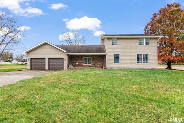 view of front of house with a garage and a front lawn