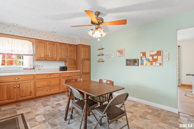 dining room with a textured ceiling and ceiling fan