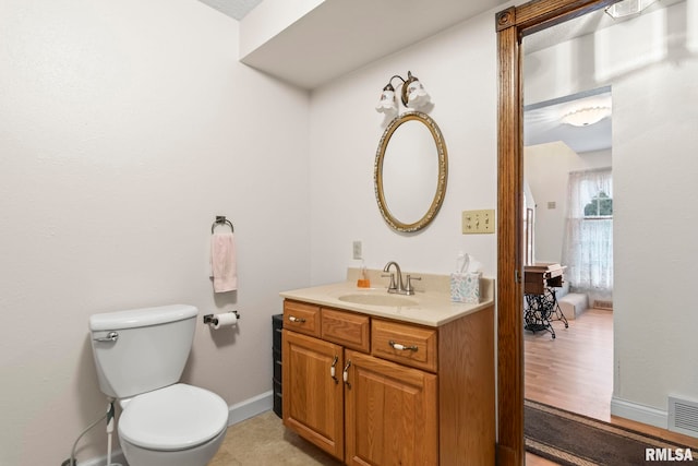 bathroom with vanity, hardwood / wood-style flooring, and toilet