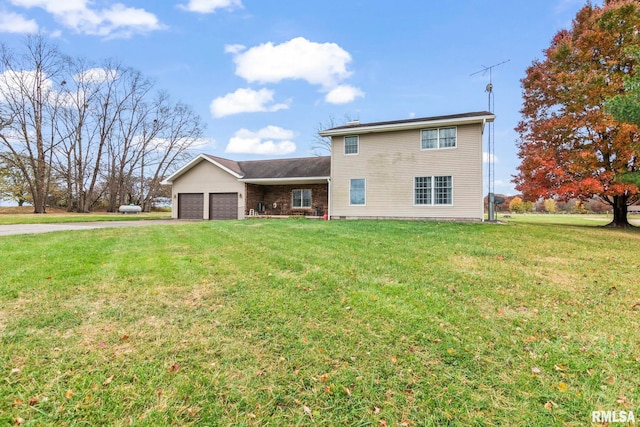 view of front of home featuring a garage and a front lawn