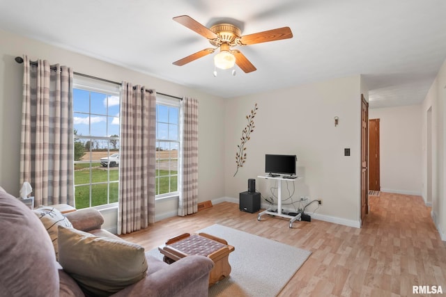 living room featuring light wood-type flooring and ceiling fan