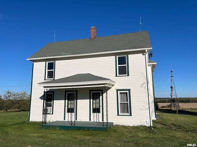 321 N County Road 1200, West Point, IL 62380 - rear view of house featuring a yard, a chimney, and covered porch