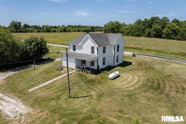 view of front facade featuring a front yard and a rural view