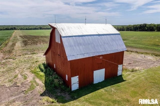 view of outdoor structure with a yard and a rural view