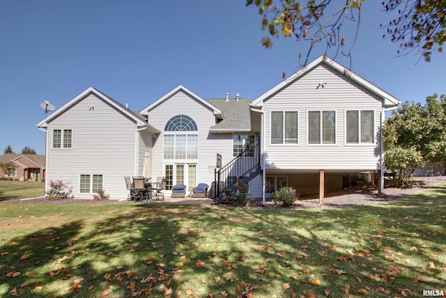 rear view of property with a yard and a patio area