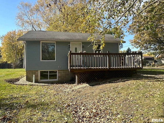 back of house featuring a wooden deck and a yard