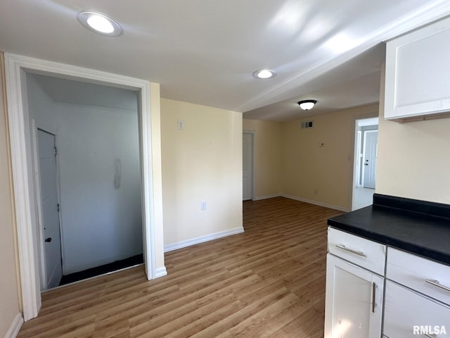 kitchen featuring white cabinetry and light wood-type flooring