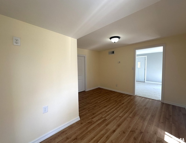 empty room with dark wood-type flooring