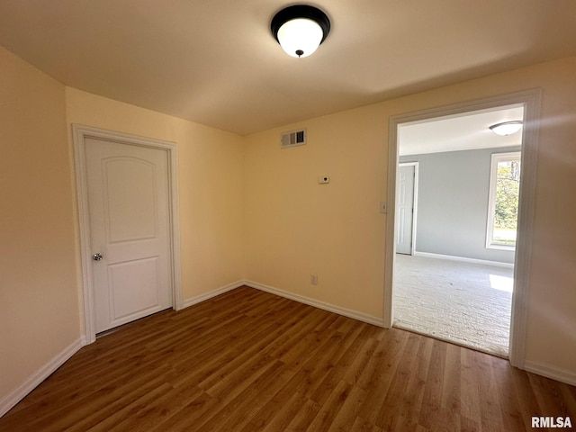 spare room featuring dark wood-type flooring