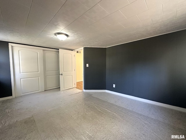 unfurnished bedroom with a closet and concrete floors