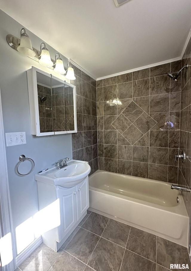 bathroom with vanity, tiled shower / bath, tile patterned floors, and crown molding