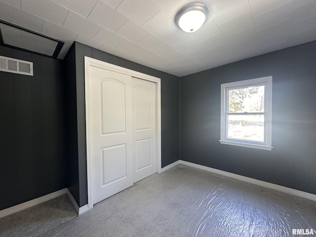 unfurnished bedroom featuring a closet and light carpet