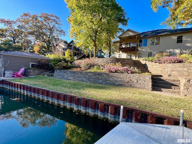 exterior space with a water view and a yard