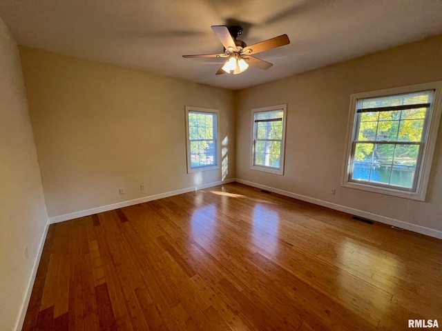 spare room with hardwood / wood-style flooring and ceiling fan