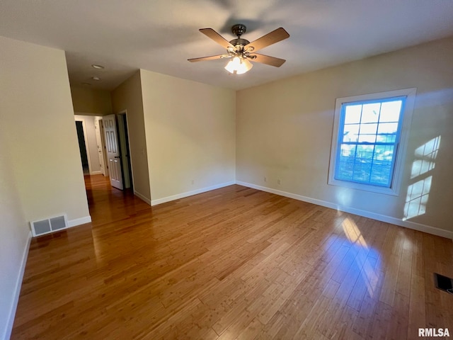 spare room with ceiling fan and hardwood / wood-style floors